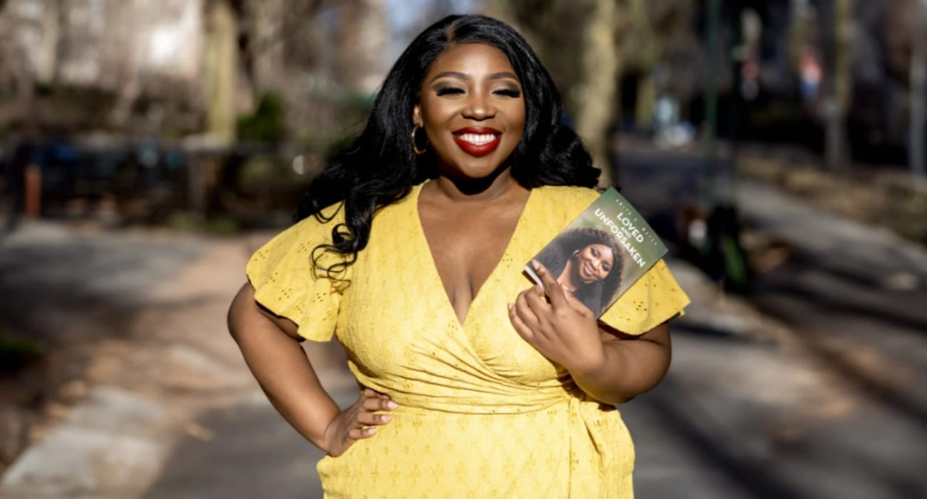 Woman in yellow dress holding a book