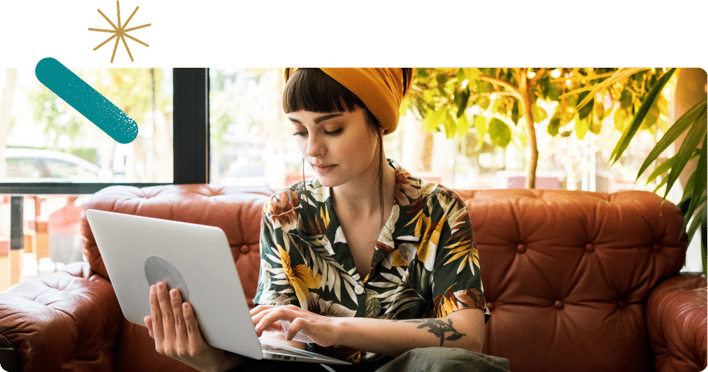 Young woman on laptop sitting on a couch