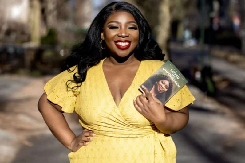 Woman in yellow dress holding a book