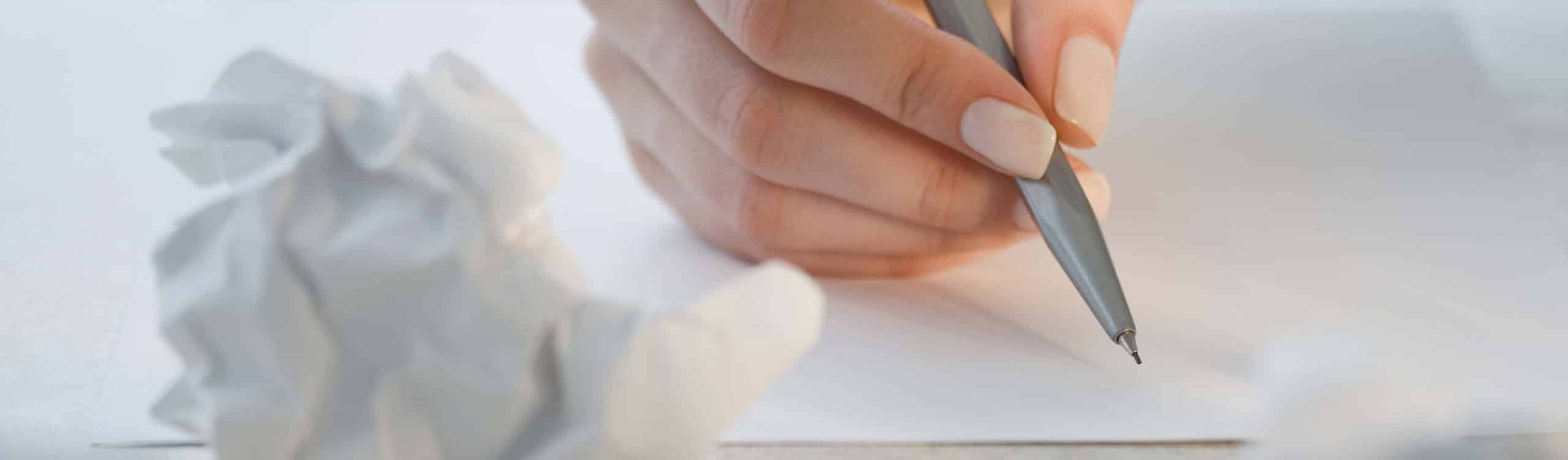 author writing on paper