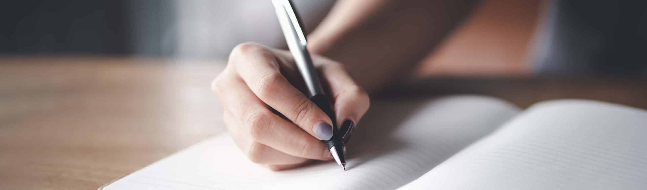 Business woman working at office with documents on his desk, Business woman holding pens and papers making notes in documents on the table, Hands of financial manager taking notes