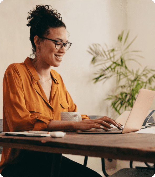 Young woman working on laptop at the table