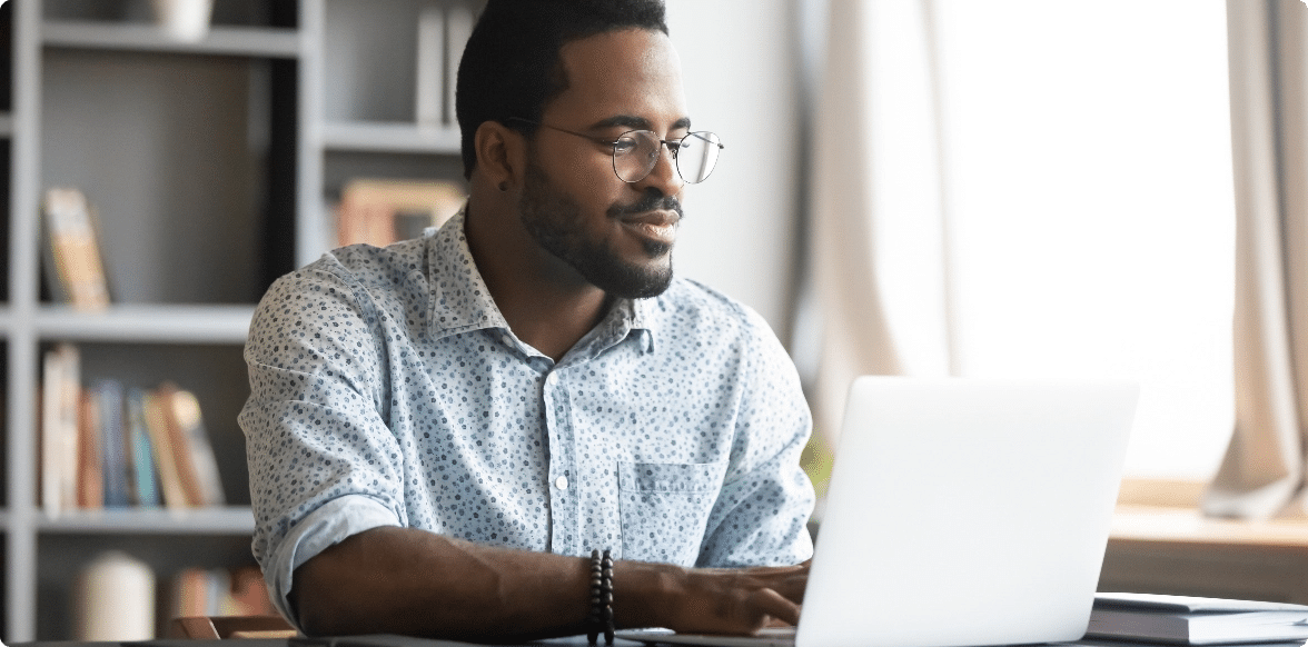 Turn Your Manuscript into a Book, Man with glasses with a computer